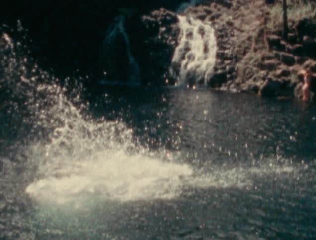 A man is jumping into a river