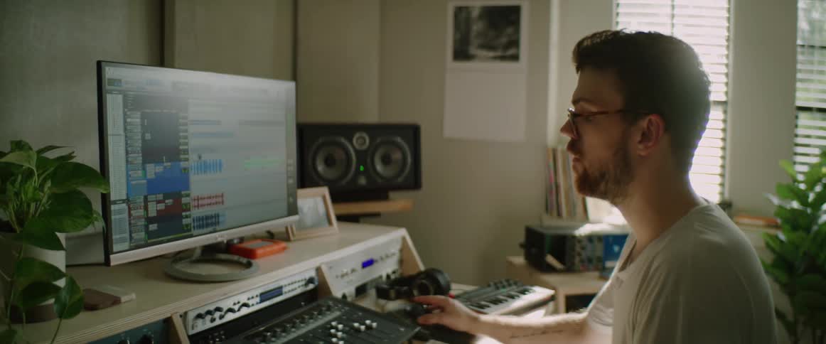 A man is looking at a computer indoors