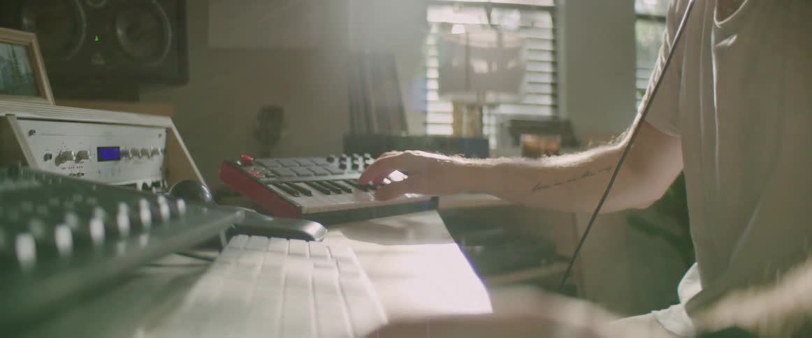 A man is playing the keyboard indoors