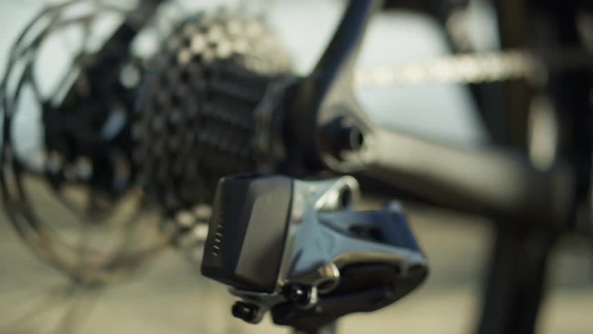 The rear chain and gears of a bicycle spin as the bicycle is pedaled