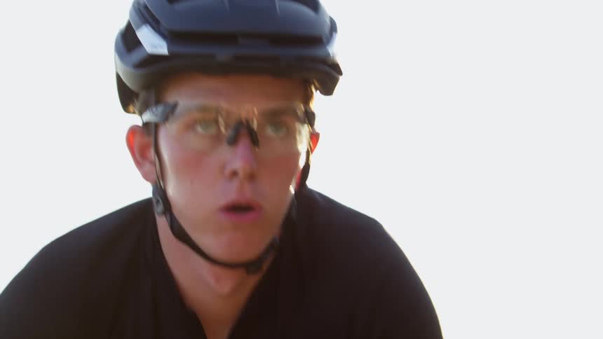 Close up of cyclist face wearing helmet and protective glasses