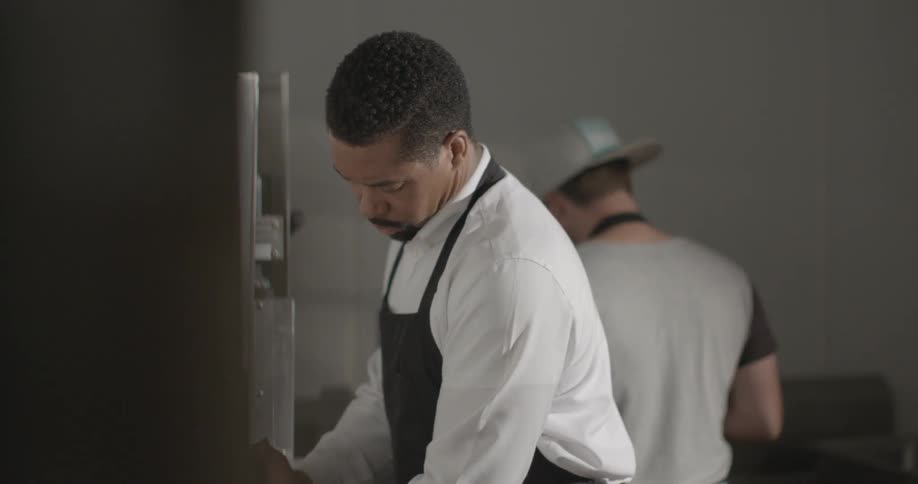 Two men are working in a kitchen