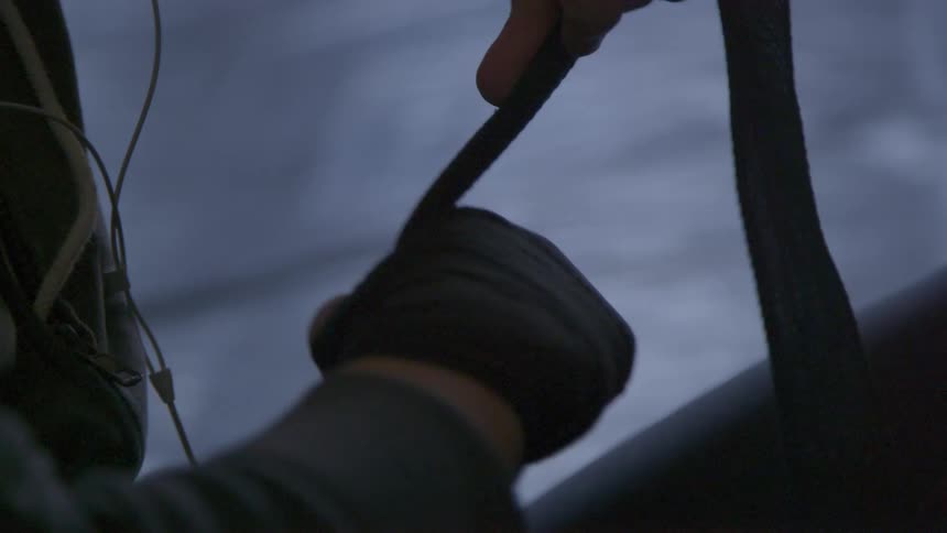 A white man twists fabric around his hand