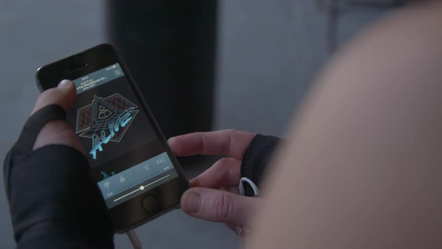 A person is picking a song on their cell phone