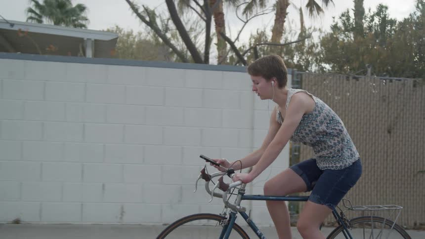 A woman is riding a bike outdoors