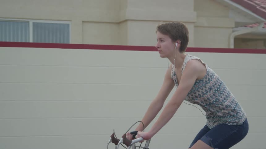 A woman is riding a bike outdoors