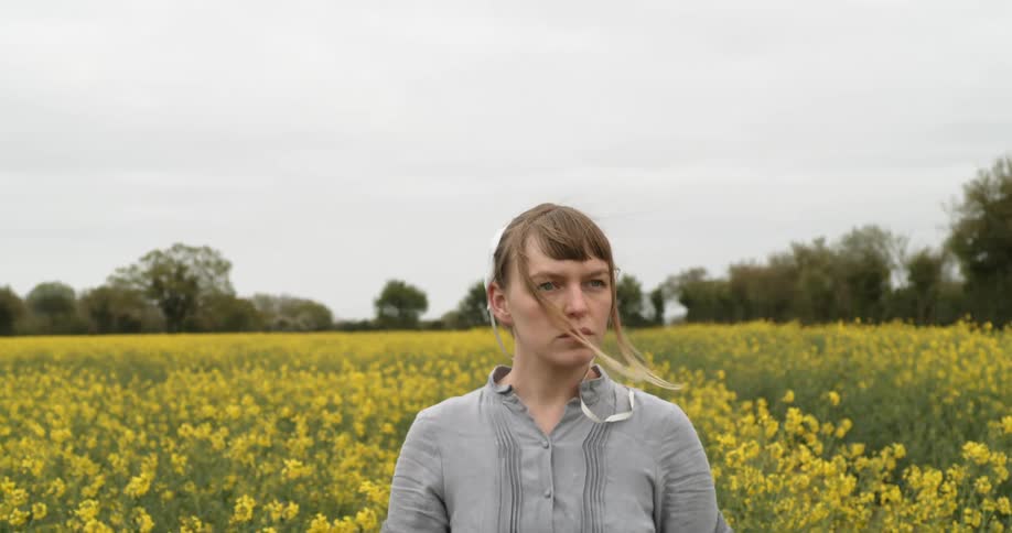 A woman stands in the field of flowers