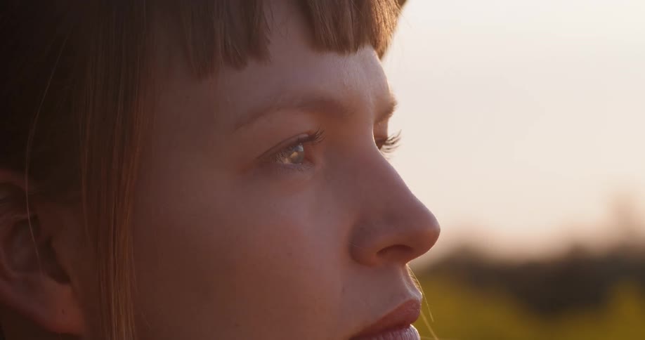 A woman blinks while looking forward