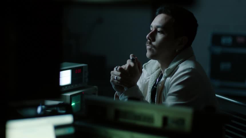 A man sits at the desk rubbing his hands