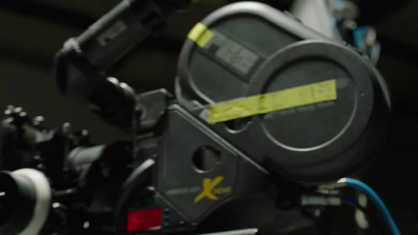 Film camera on a tripod inside a studio