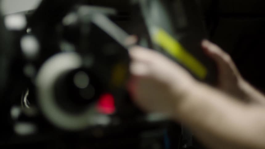A person removes a canister with film