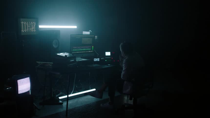 A man sits in the chair watching the monitors