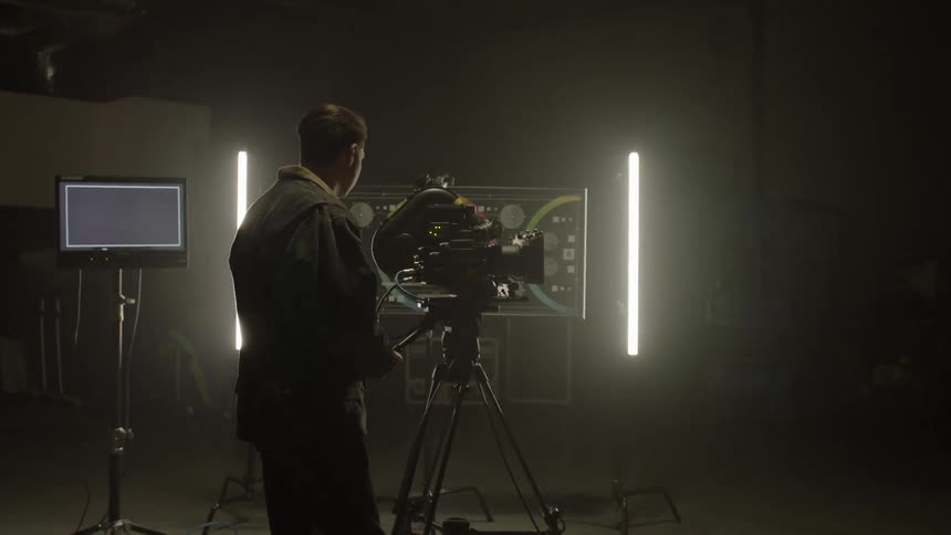 A man walks over to the camera to begin filming