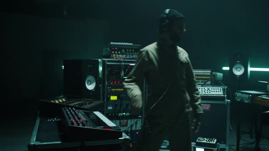 A man is working on musical equipment