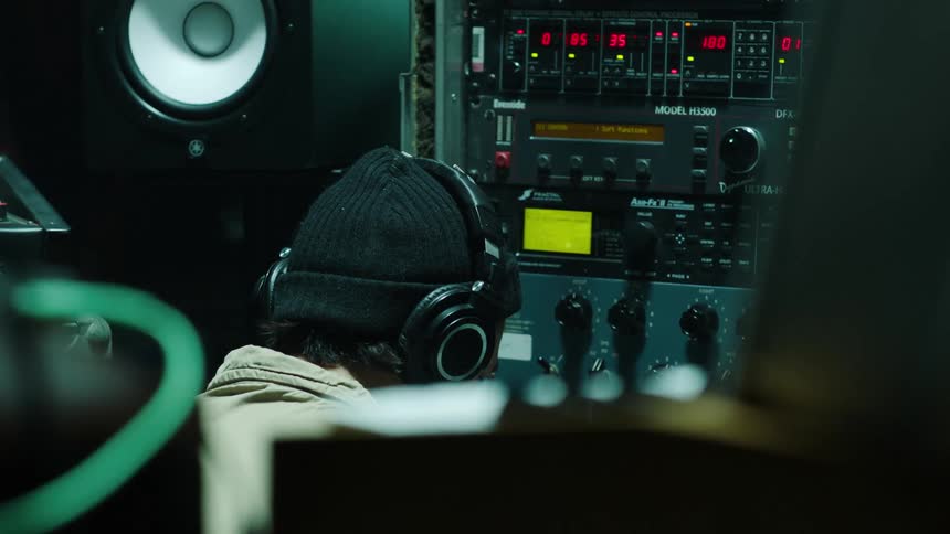 A man works on audio equipment