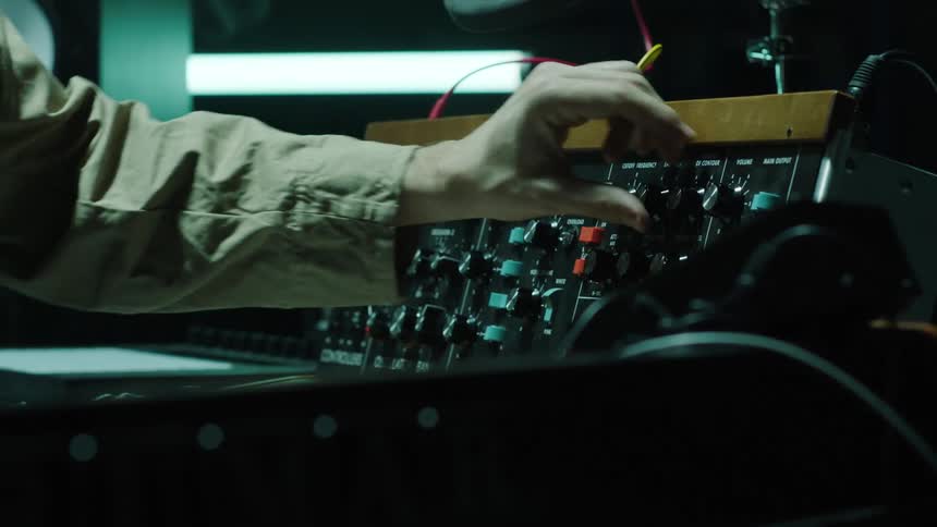 A person quickly turns the knobs on the panel