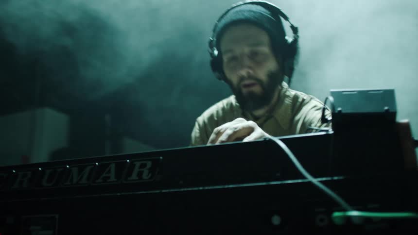A man is in a studio playing music