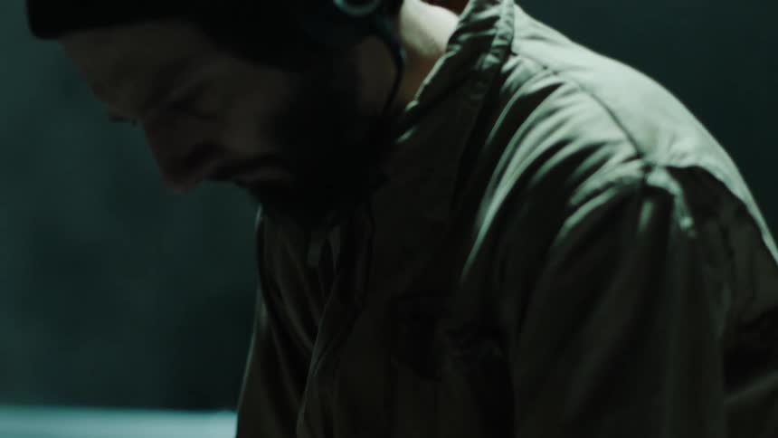 A musician bobs his head to music that hes creating