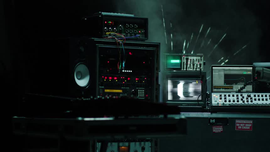 Electronic devices sit as fireworks explode behind them