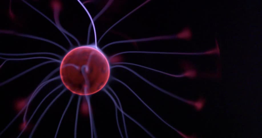 A plasma ball is glowing in the dark