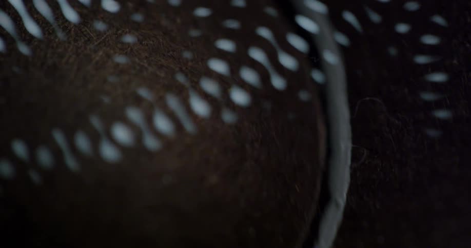 A shimmering pattern of lights appears over a brown substance in a container