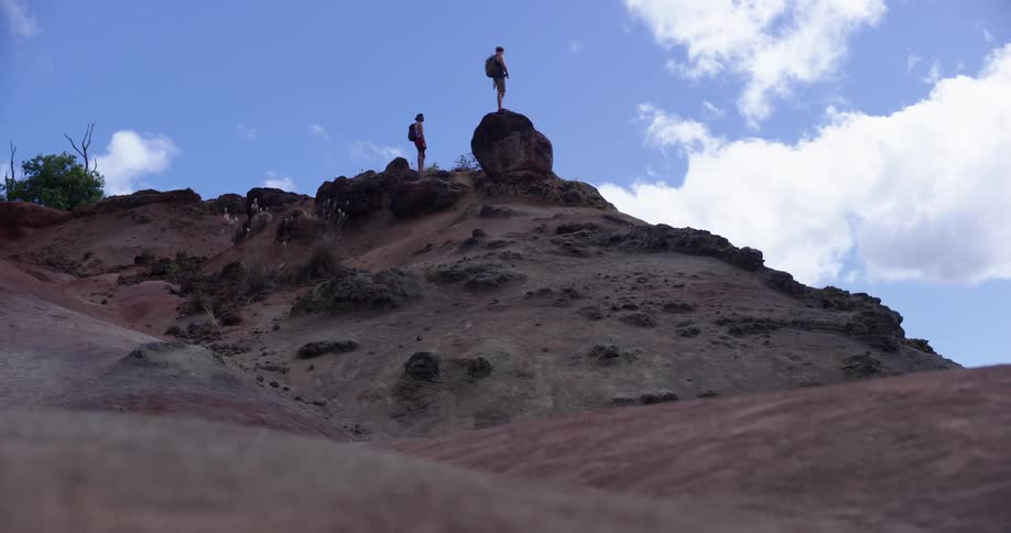 Two people are standing on top of a mountain