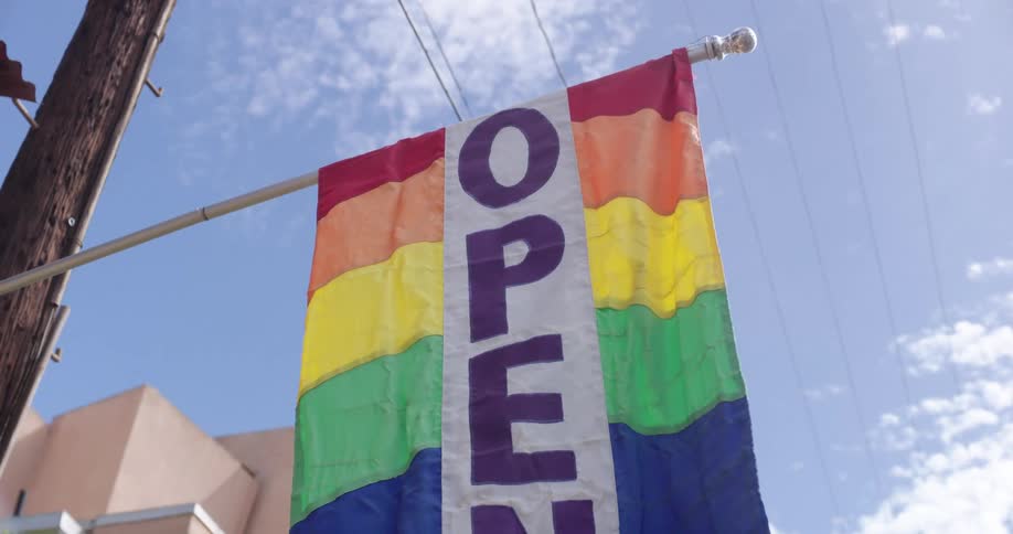 An open banner hangs outside a store
