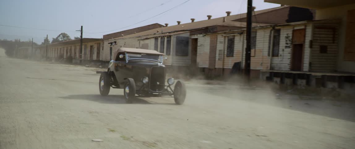 Vintage hot rods race down the road
