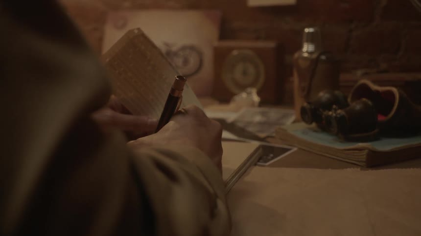 Someone writing in a book