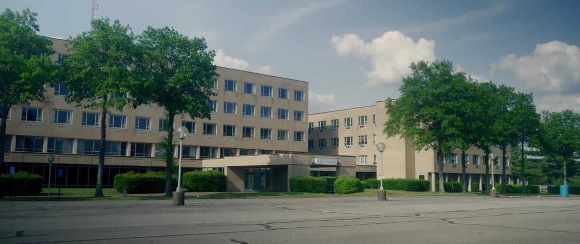 A building complex sits off a road