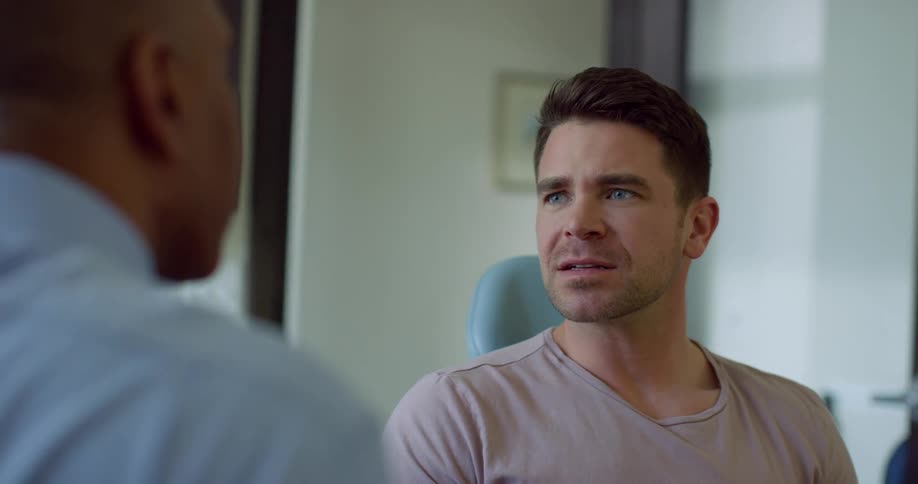 Two men talk while sitting in a room