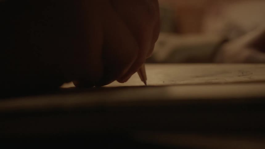 Someone writing in a notebook