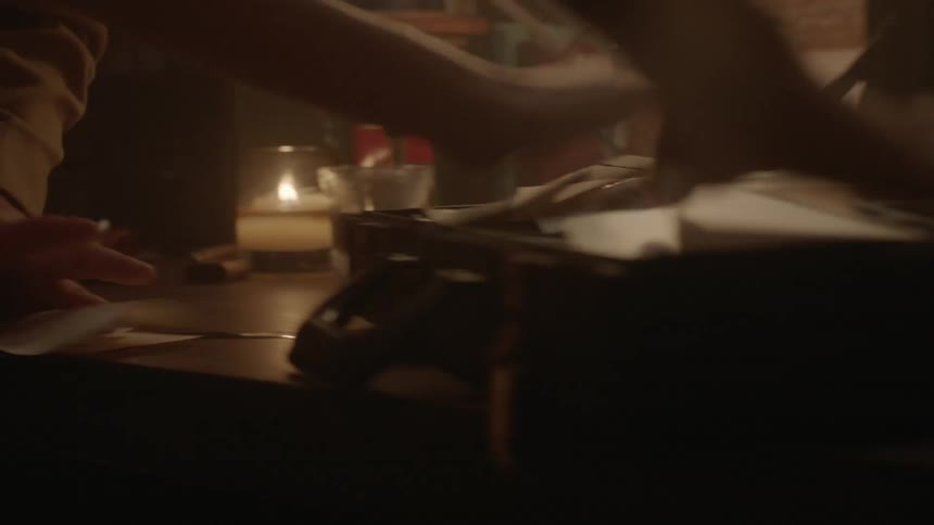 Person frantically throwing papers into a briefcase