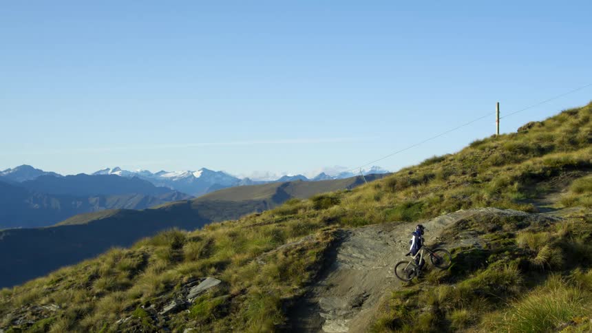 A man pushes his bike up a hill