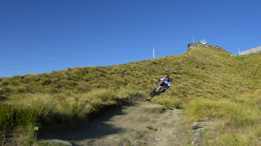 A male mountain bikes down a steep hill