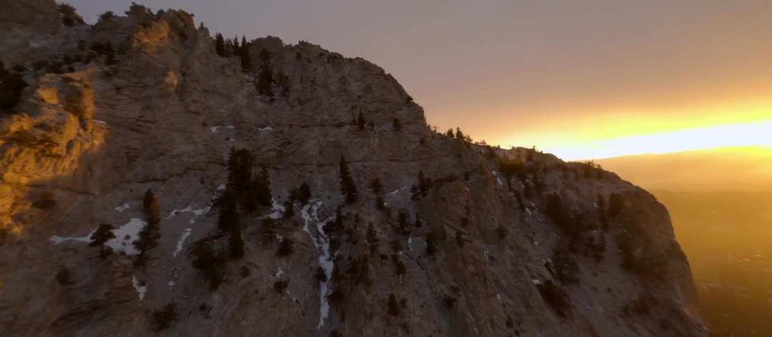 The sun behind a mountain range