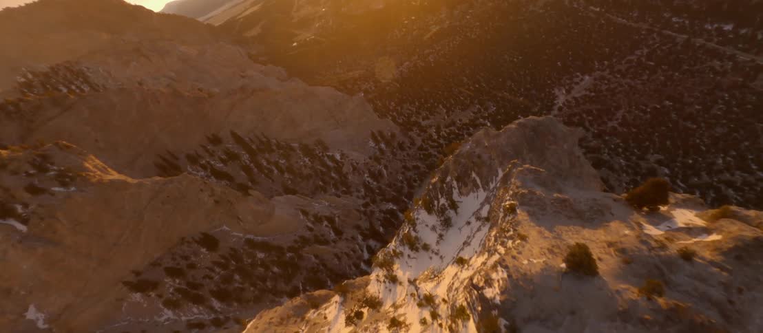 The sun is rising over the mountain range