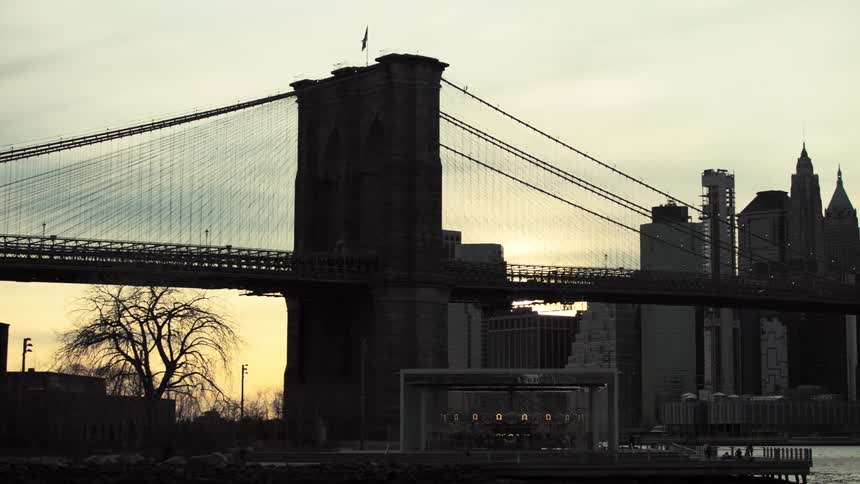 Cars driving across a bridge in a city