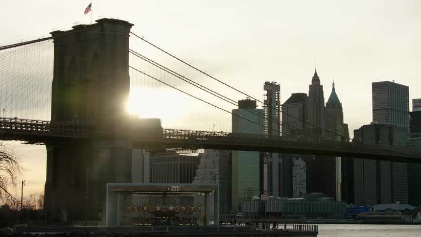 Cars driving across a bridge heading in to the city