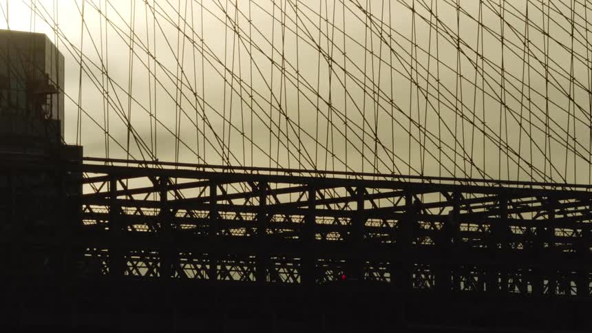 Cyclists pedestrians and vehicles crossing Brooklyn Bridge Silhouette