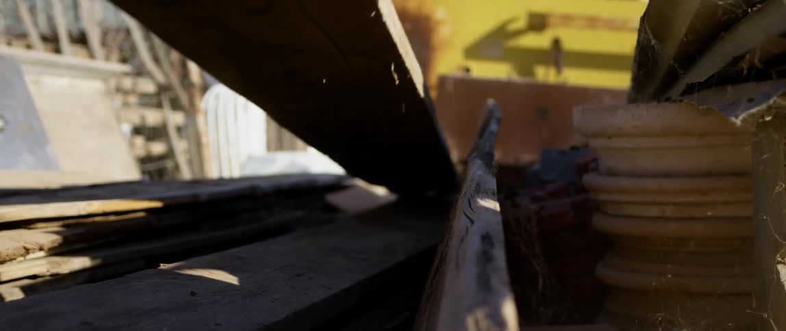 A person lies a plank of wood down