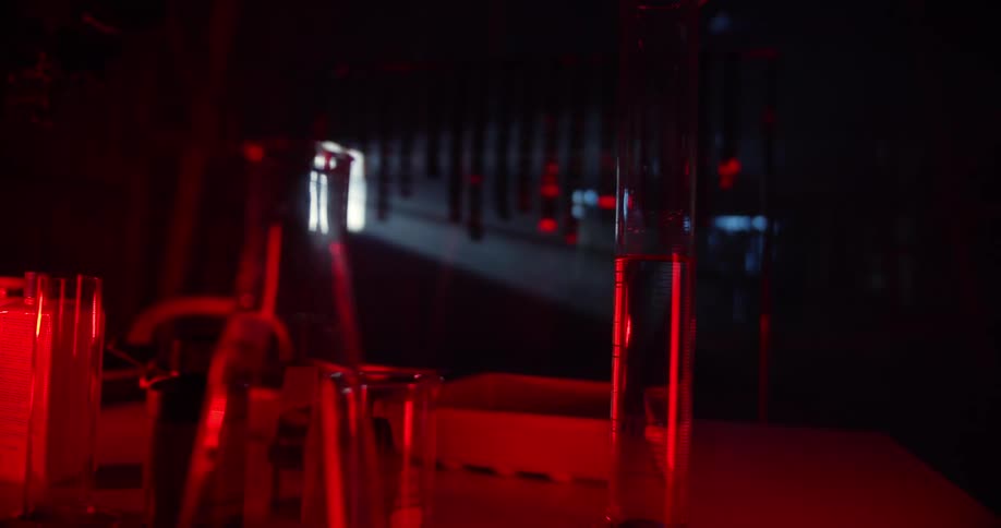 Laboratory equipment under red light on a dimly lit room