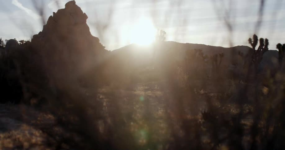 A person hikes at the base of a cliff