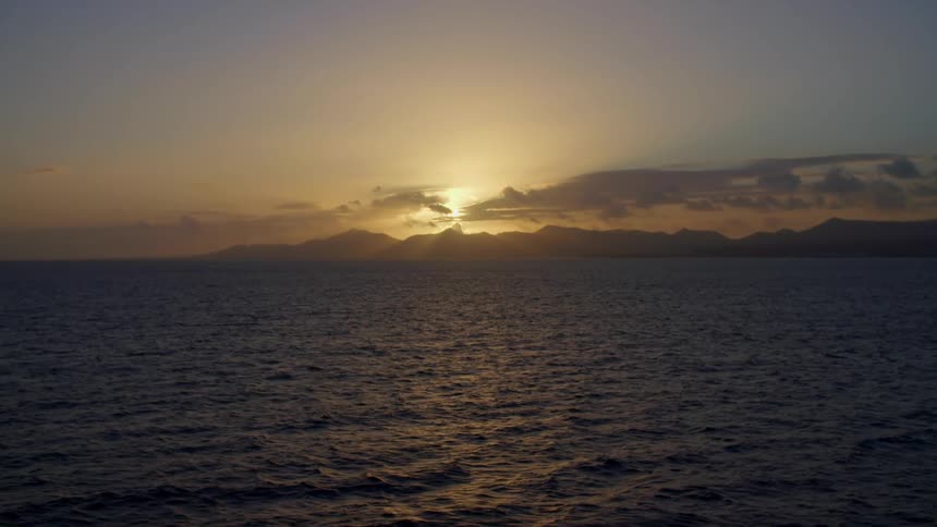 The sun setting over the ocean