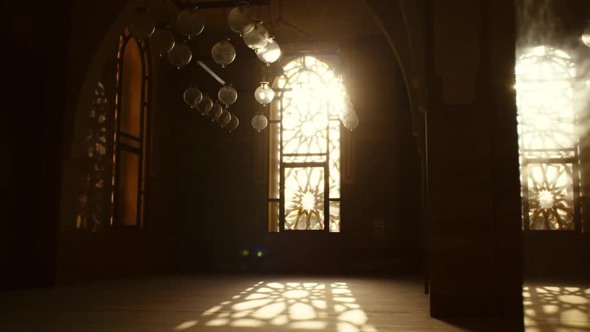 Sunlight illuminates the interior of an empty cathedral