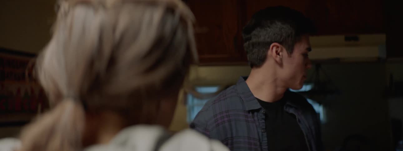 A husband is talking to his wife in a house