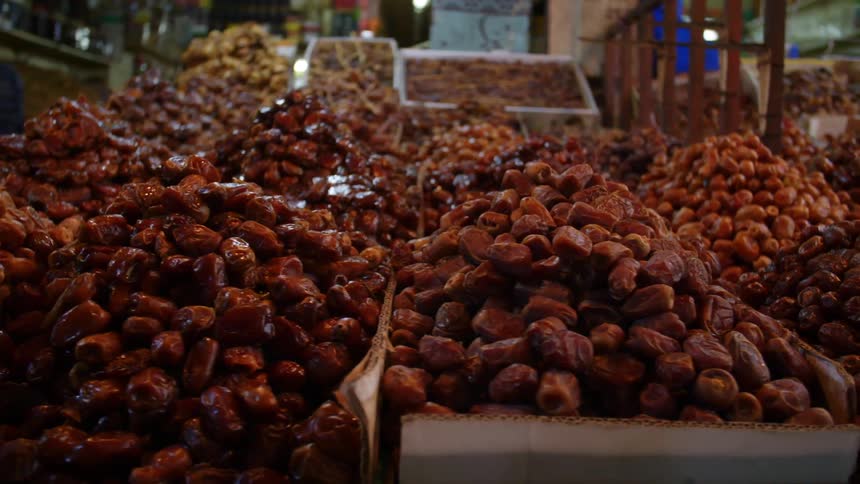 Boxes with piles of fresh dates on a market