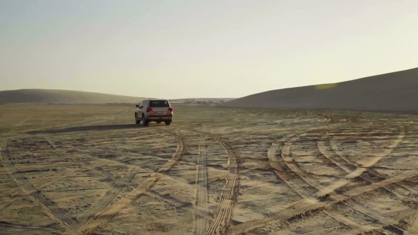 A car driving across the desert