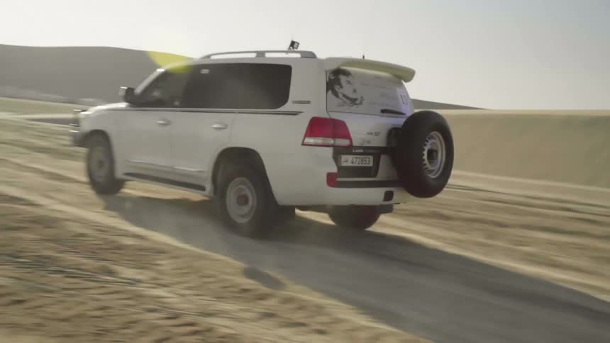 Cars driving across a desert area