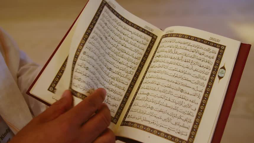 Man leafs through the koran